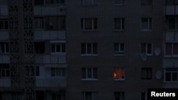 A single light illuminates a room Nov. 24, 2015, during a blackout at a residential building in Simferopol, Crimea. Crimea continued to rely on emergency generators to meet its basic power needs.