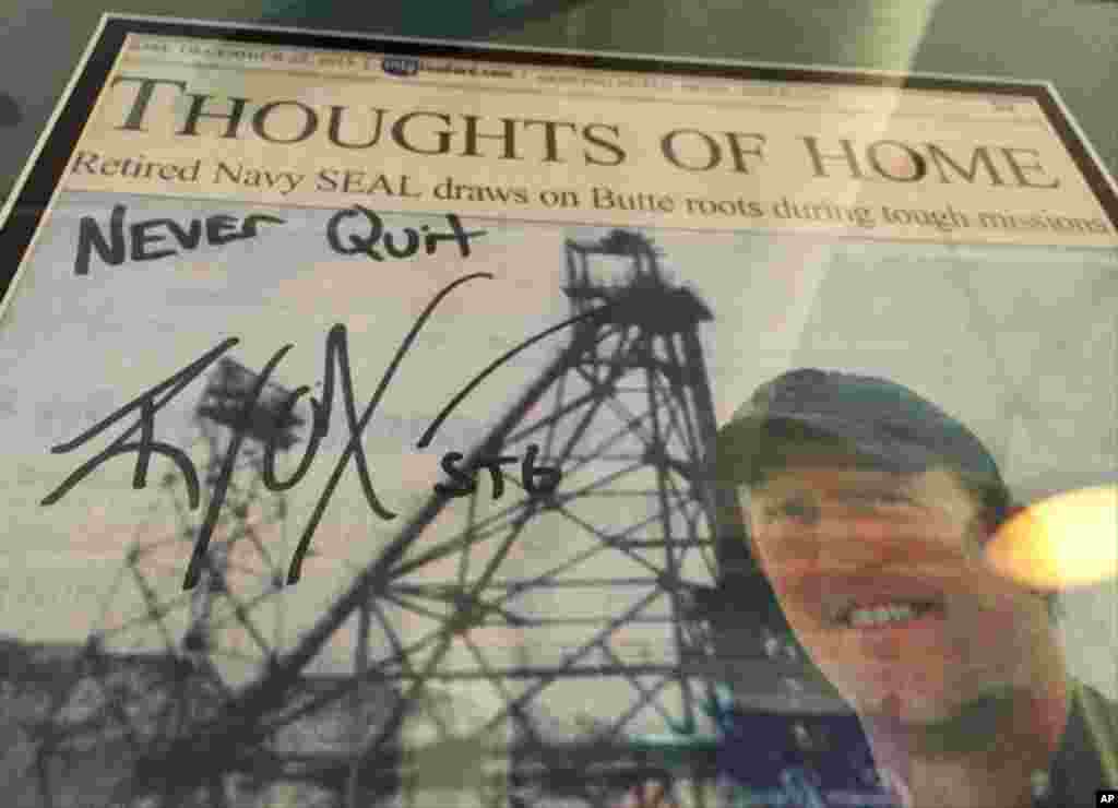 A framed Montana Standard newspaper article on Robert O&#39;Neill, with his autograph, is seen on the wall of the Metals Sports Bar in Butte, Montana, Nov. 6, 2014. 