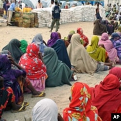 Internally displaced Somali women queue to receive food-aid rations at a distribution center in a displaced persons camp in the Somali capital Mogadishu, July 26, 2011