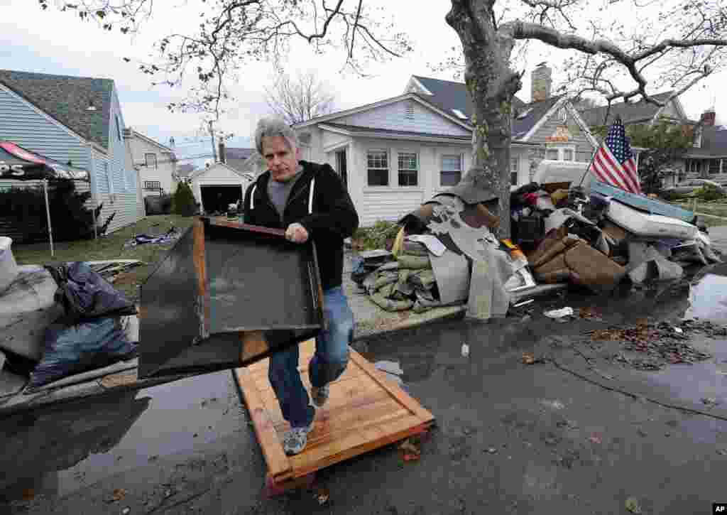 Dave Skudin empties his home of household items that were destroyed by flooding from Superstorm Sandy on Nov 1, 2012, in Long Beach, N.Y.