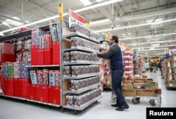 An employee works on a display ahead of Black Friday at a Walmart store in Chicago, Illinois, U.S., Nov. 20, 2018.