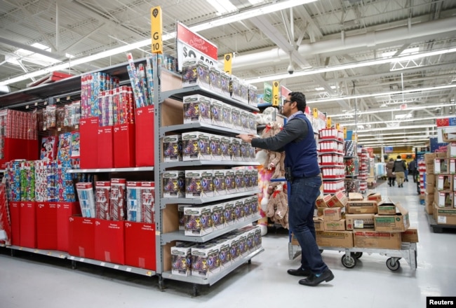An employee works on a display ahead of Black Friday at a Walmart store in Chicago, Illinois, U.S., Nov. 20, 2018.