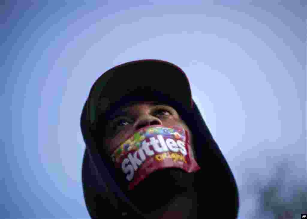 Jajuan Kelley, of Atlanta, wears a Skittles wrapper over his mouth during a rally in memory of Trayvon Martin, the unarmed 17-year-old who was killed by a Florida neighborhood watch captain while returning from a convenience store with a bag of Skittles a