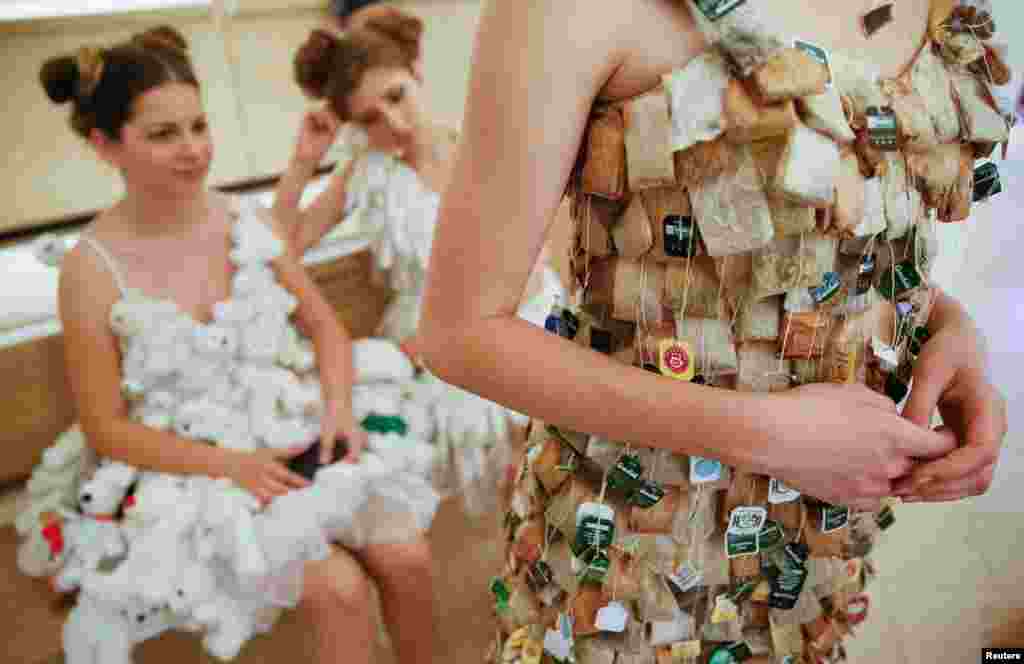 Models rest backstage after a runway show by French eco-designer Isagus Toche, as a part of an ecological forum, in Kyiv, Ukraine.