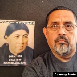 Disenrolled Luiseno Pechanga Indian Rick Cuevas stands beside a portrait of his ancestor, Paulina Hunter, who was stripped of tribal membership posthumously.
