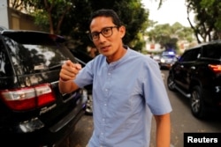 FILE - Indonesian vice president candidate Sandiaga Uno gestures as he walks in front of his house in Jakarta, Indonesia.