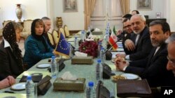 The European Union's foreign policy chief Catherine Ashton (2nd L) and her delegation attend a meeting with Iranian Foreign Minister Mohammad Javad Zarif (2nd R) and his colleagues in Tehran, Iran, March 9, 2014.