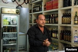 A liquor store owner waits for customers inside his shop, after it was banned during the Islamic State militants' seizure of the city, in Mosul, Iraq, April 18, 2019.