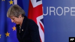 British Prime Minister Theresa May leaves after addressing a media conference at an EU summit in Brussels, March 22, 2019. 
