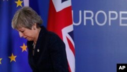 FILE - British Prime Minister Theresa May leaves after addressing a media conference at an EU summit in Brussels, March 22, 2019. 