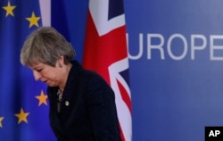 FILE - British Prime Minister Theresa May leaves after addressing a media conference at an EU summit in Brussels, March 22, 2019.