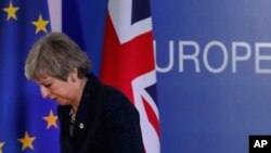 FILE - British Prime Minister Theresa May leaves after addressing a media conference at an EU summit in Brussels, March 22, 2019. 