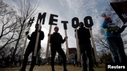 Demonstrators spell out "#MeToo" during a local Women's March in Cambridge, Mass., Jan. 20, 2018. 