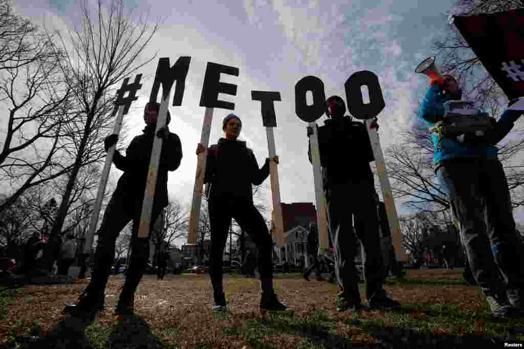 Demonstrators spell out "#MeToo" during the local second annual Women's March in Cambridge, Mass., Jan. 20, 2018. 