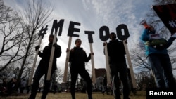 Demonstrators spell out "#MeToo" during the local second annual Women's March in Cambridge, Mass., Jan. 20, 2018.