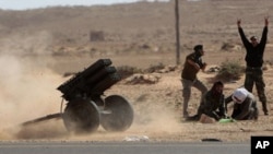Libyan rebels fire multiple launcher rockets during a fight against pro-Gadhafi fighters near the town of Bin-Jawad, eastern Libya, Sunday, March 6, 2011.