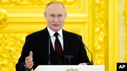 FILE - Russian President Vladimir Putin speaks in the Kremlin, in Moscow, Russia, Dec. 1, 2021.