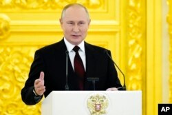 Russian President Vladimir Putin speaks in the Kremlin, in Moscow, Russia, Dec. 1, 2021.