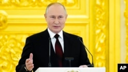 Russian President Vladimir Putin speaks in the Kremlin, in Moscow, Russia, Dec. 1, 2021.