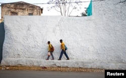 FILE - Students walk within the walled city of Harar, Ethiopia, Feb. 24, 2017.