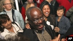 Peter Bossman, center, a Ghana-born physician celebrates his electoral victory in Piran, Slovenia, late Sunday, 24 Oct. 2010