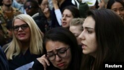 FILE - Woman embrace each other during a protest against President-elect Donald Trump in Manhattan, New York, Nov. 13, 2016. Feeling threatened by comments Trump made during the campaign, tens of thousands of women have pledged to march in Washington a day after his inauguration.