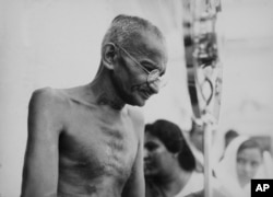 FILE - Mahatma Gandhi in a photo from a period album collected by AP reporter James A. Mills, ca. 1931.