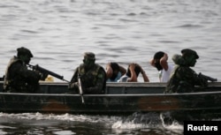 Brazilian Army soldiers patrol the border with Colombia during a training to show efforts to step up security along borders, in Vila Bittencourt, Amazon State, Brazil, Jan. 18, 2017.