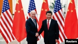 Chinese President Xi Jinping shakes hands with U.S. Vice President Joe Biden (L) inside the Great Hall of the People in Beijing, Dec. 4, 2013.
