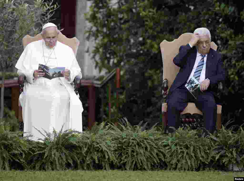 Pope Francis and Palestinian President Mahmoud Abbas are pictured in the Vatican Gardens as they pray with Israeli President Shimon Peres (not pictured) at the Vatican, June 8, 2014.