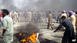 Pakistani protesters burn tires to block the main highway in Rawalpindi, Pakistan, September 21, 2012.