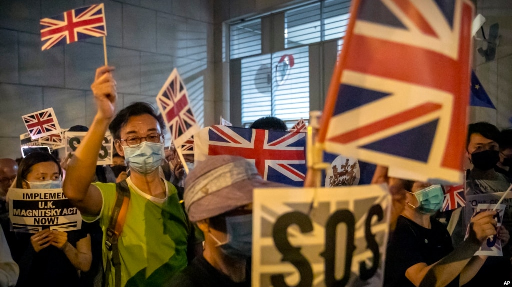 In this Oct. 23, 2019, file photo, demonstrators wave British flags during a rally outside the British Consulate in Hong Kong. (AP Photo/Mark Schiefelbein, File)
