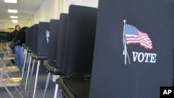 FILE - Voting booths are lined up in Albuquerque, New Mexico, Oct. 26, 2012. 