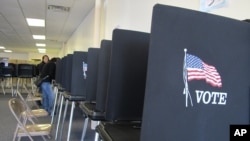 FILE - Members of the Native American Voters Alliance mark their ballots at an early voting center in Albuquerque, New Mexico, Oct. 26, 2012.