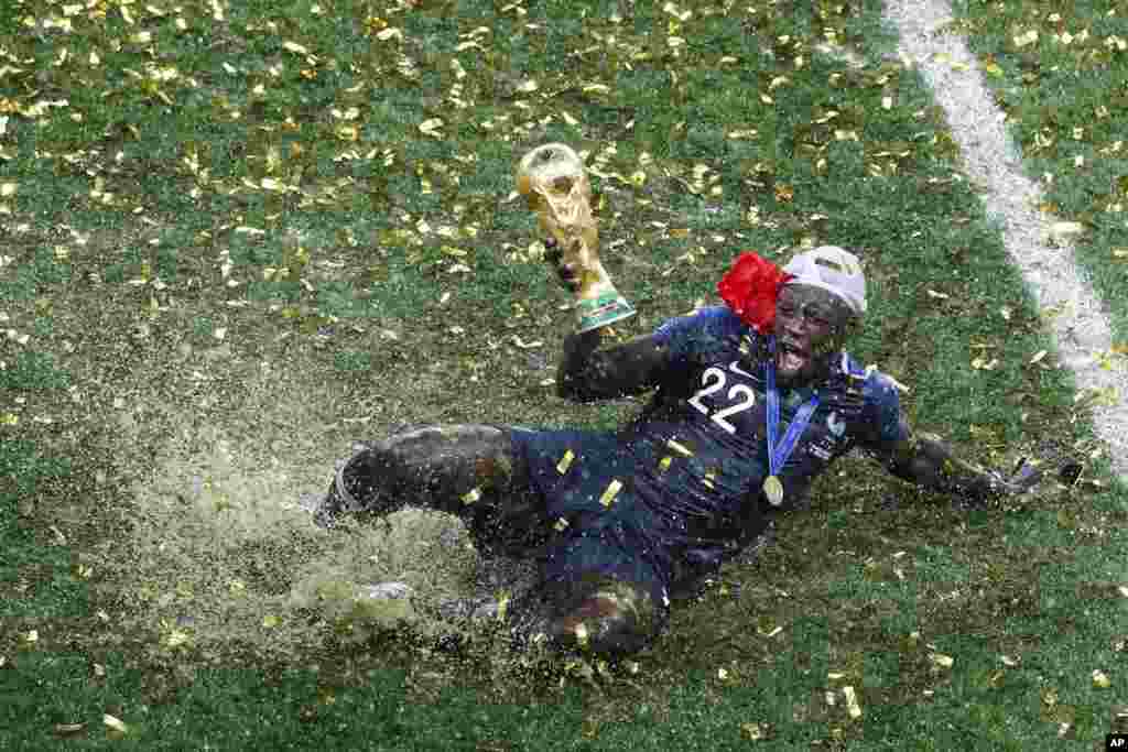 France's Benjamin Mendy celebrates with the trophy after his team won the final match against Croatia at the 2018 soccer World Cup in the Luzhniki Stadium in Moscow, Russia, July 15, 2018.