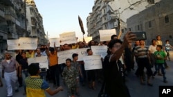 Activists in Syria’s besieged Aleppo rally against the United Nations for what they say is its failure to lift the siege of their rebel-held area, Sept. 13, 2016.