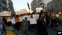 Activists in Syria’s besieged Aleppo protest against the United Nations for what they say is its failure to lift the siege of their rebel-held area, Sept. 13, 2016. Dozens of protesters marched in the al-Shaar neighborhood heading toward the Castello road, the area from which aid is expected to be delivered. 