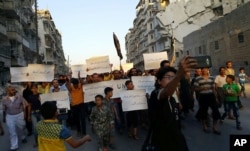 FILE - Activists in Syria’s besieged Aleppo protest against the United Nations for what they say is its failure to lift the siege of their rebel-held area, Sept. 13, 2016.
