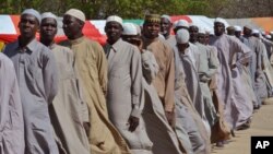 Men who were being detained on suspicion of affiliation to Boko Haram, line up as they are released by the Nigerian military in Maiduguri, Nigeria, July 6, 2015