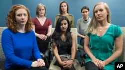 Annemarie Brown, Andrea Courtney, and Marissa Evansin, and from left front row, Sasha Brietzke, Vassiki Chauhan, Kristina Rapuano, take a picture together in New York. The six women, plus one more, have taken legal action against Dartmouth College. (AP Photo/Mary Altaffer)
