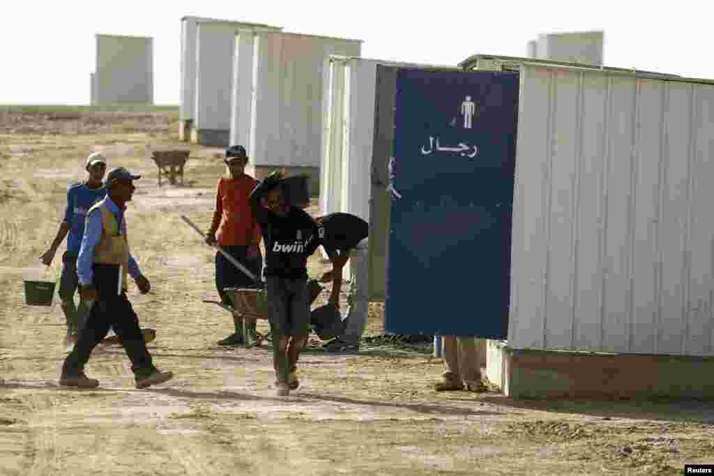 Jordanian workers prepare materials to build the Azraq Syrian Refugee Camp near Al Azraq, east of Amman, Sept. 1, 2013.