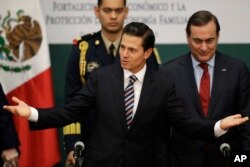 Mexico's President Enrique Pena Nieto greets guests at an event announcing an accord meant to strengthen the national economy and keep down household costs, in Mexico City, Jan. 9, 2017.