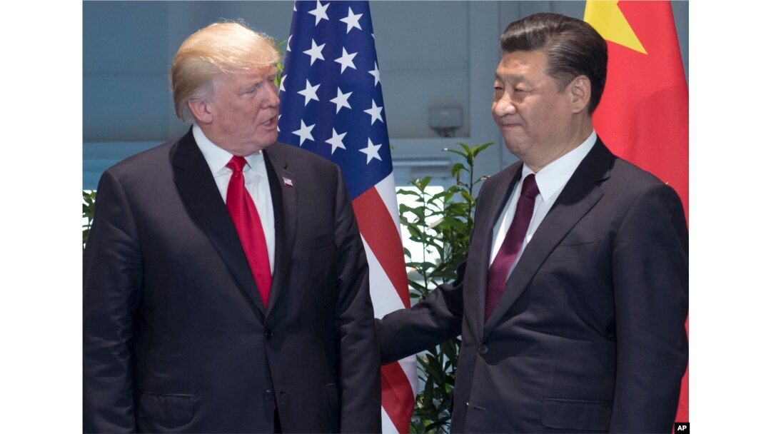 FILE - , U.S. President Donald Trump, left, and Chinese President Xi Jinping arrive for a meeting on the sidelines of the G-20 Summit in Hamburg, Germany.