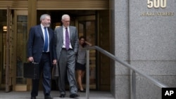Jonathan Blackman, left, an attorney representing Argentina in their ongoing debt issues, leaves the Federal court in New York, Sept. 29, 2014.