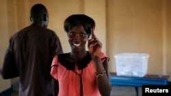 A woman shows her ink-stained finger after casting her ballot at a polling station located in a school during a referendum in the town of Abyei, Oct. 27, 2013. 