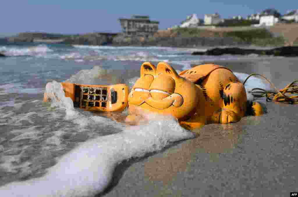 A plastic &#39;Garfield&#39; phone is displayed on the beach in Le Conquet, western France, March 30, 2019.