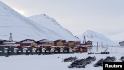 Snow scooters are seen parked in the town of Longyearbyen in Svalbard, March 26, 2012. 