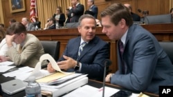 FILE - Rep. David Cicilline, D-R.I., center, talks with Rep. Eric Swalwell, D-Calif., right, during a House Judiciary Committee meeting on Capitol Hill, June 26, 2018.