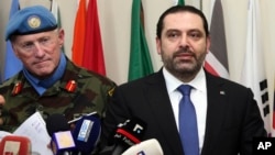 Lebanese Prime Minister Saad Hariri, right, speaks to journalists, as he stands next of Head of Mission and Force Commander of UNIFIL, Maj. Gen. Michael Beary, left, at U.N. peacekeepers headquarters, at the coastal border town of Naqoura, south Lebanon, April 21, 2017. 
