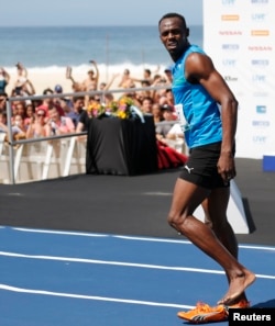 Jamaican Olympic gold medallist Usain Bolt looks on after winning the "Mano a Mano" men's 100 metres challenge on Copacabana beach in Rio de Janeiro on Aug. 17, 2014.